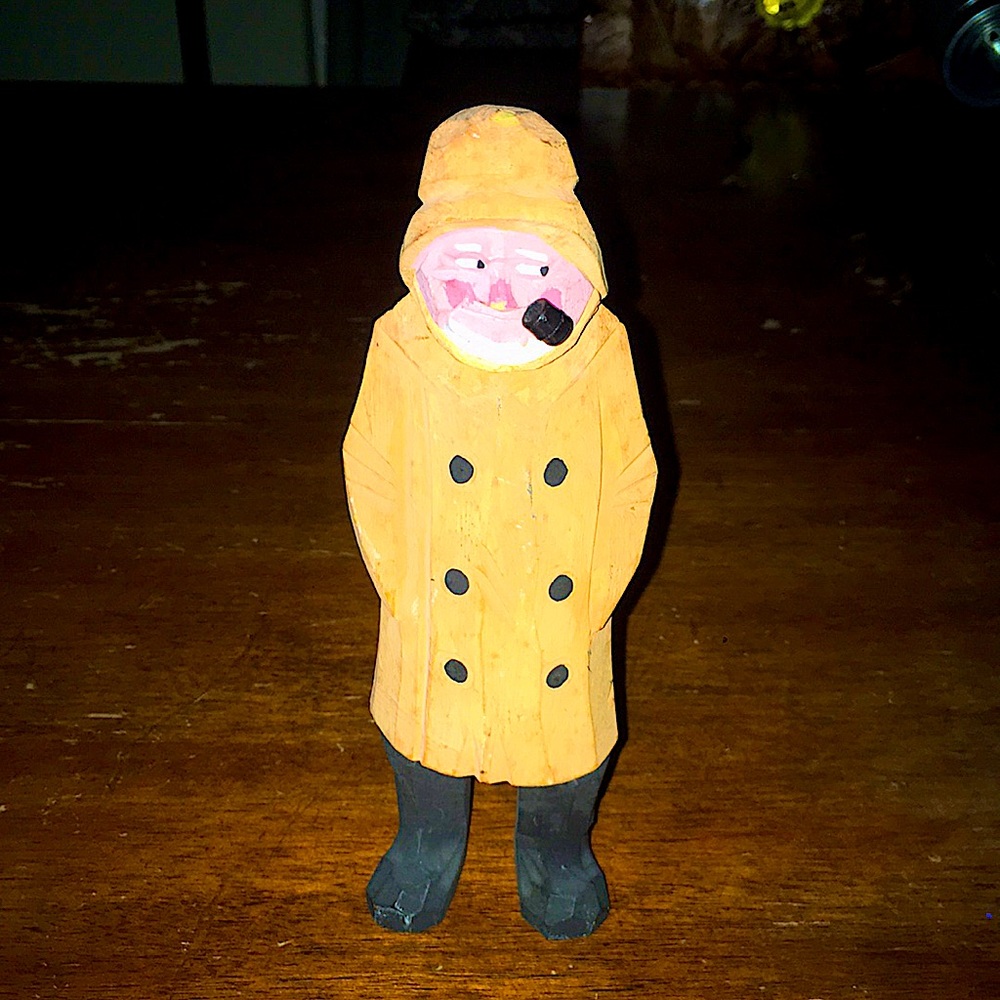 Antique fisherman carved from wood.
